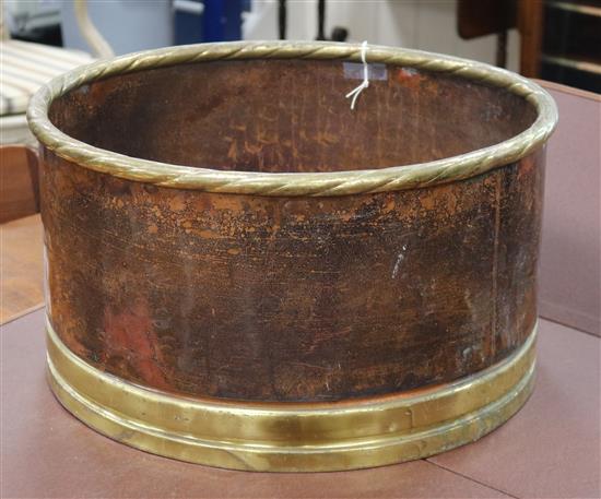 A circular copper and brass log bin W.52cm